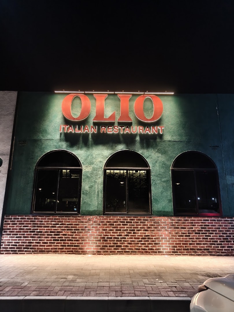 The real Olio facade and illuminated signage in Firq